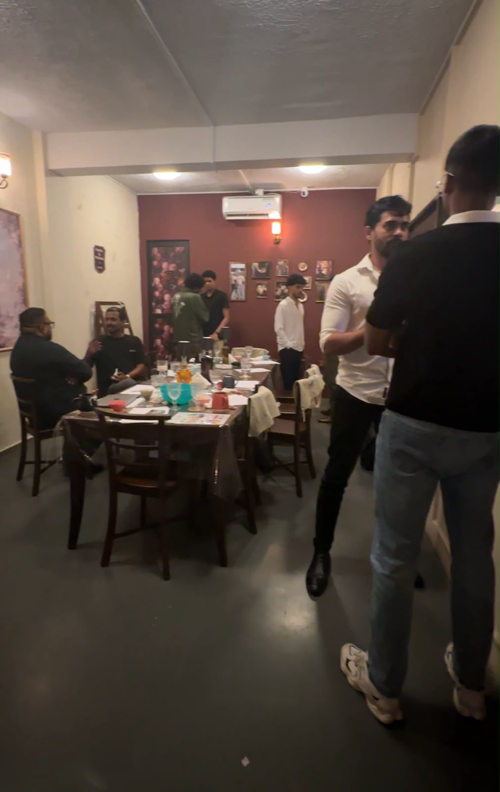 Men talking together around a table at That Sunday Circle