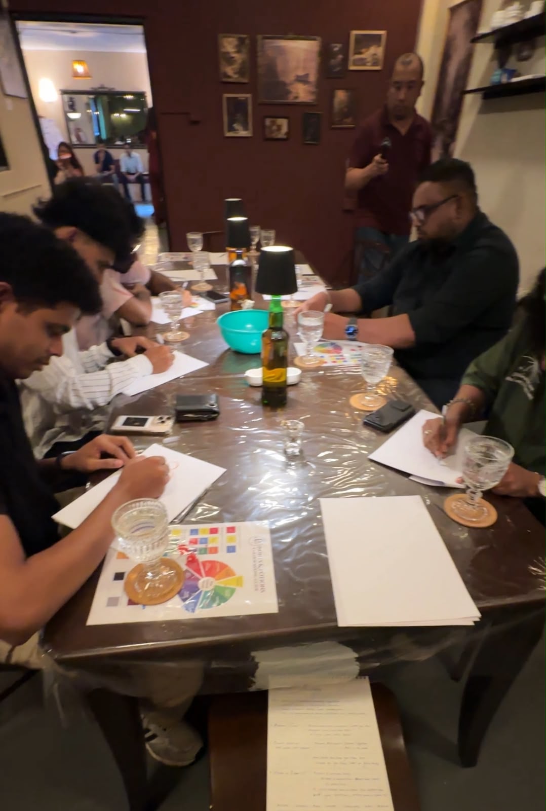 Circle members writing together around a table